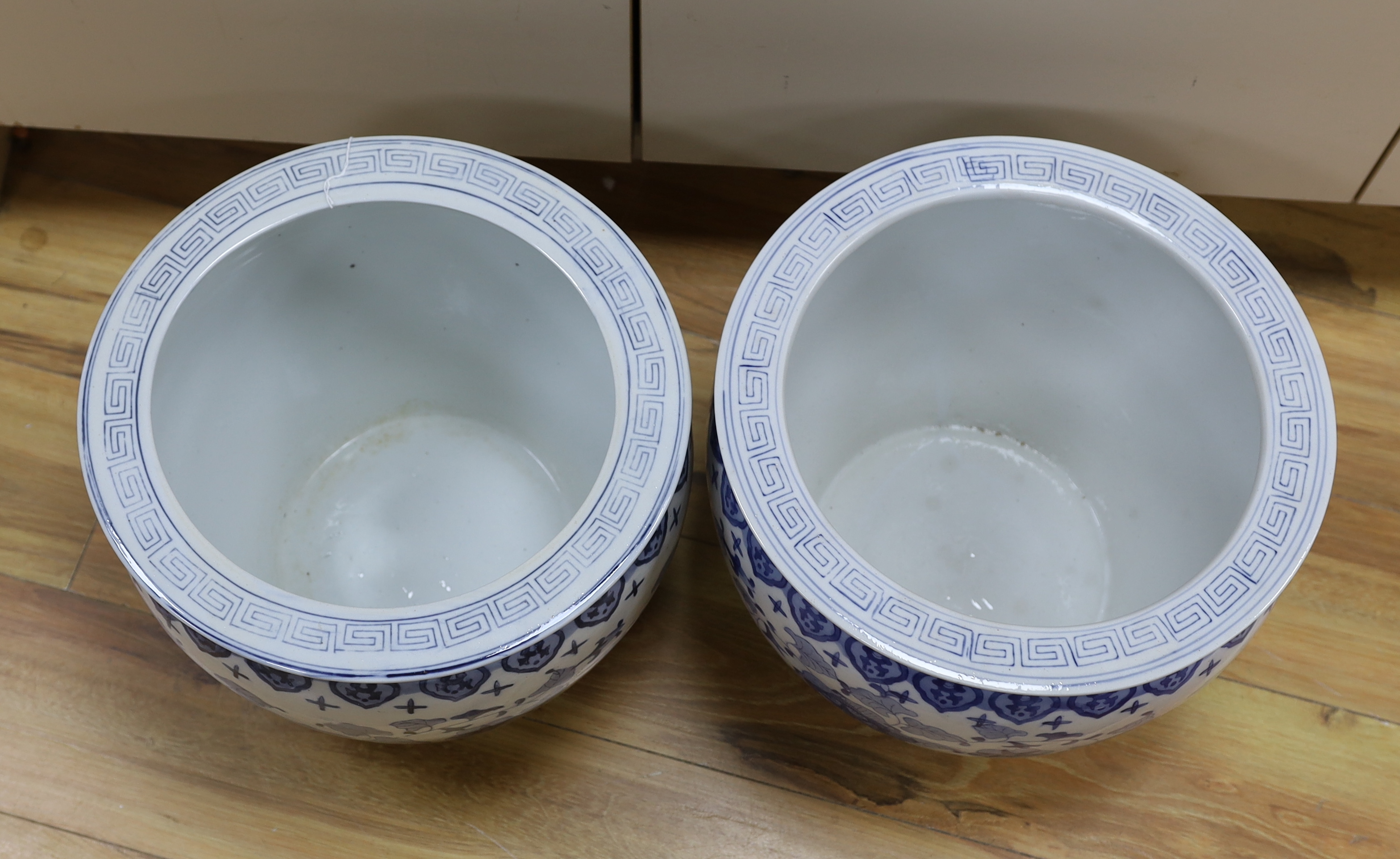A pair of 20th century Chinese blue and white fish bowls, 29cm high